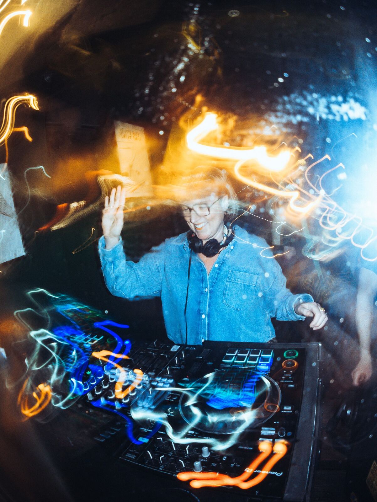 LooCee DJing at a club night in Sheffield, long exposure shot with light trails around the decks